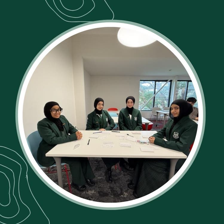 Debating students sitting around a table